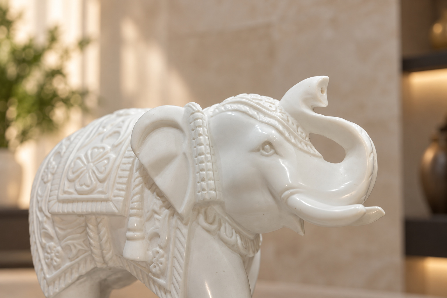 Close-up of a marble elephant's carved ear and raised trunk